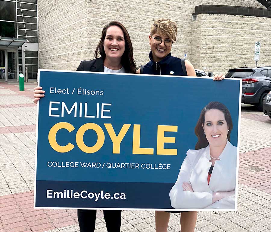 Emilie Coyle and myself holding her lawn sign